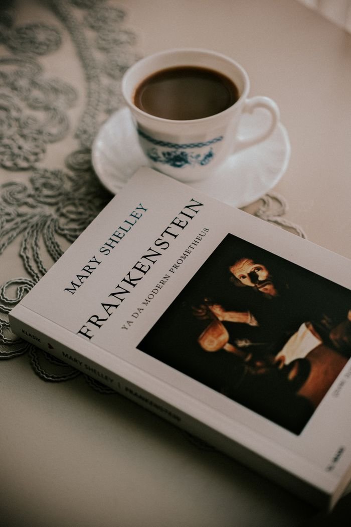 Capture a quiet moment with Mary Shelley's Frankenstein and a warm cup of coffee.